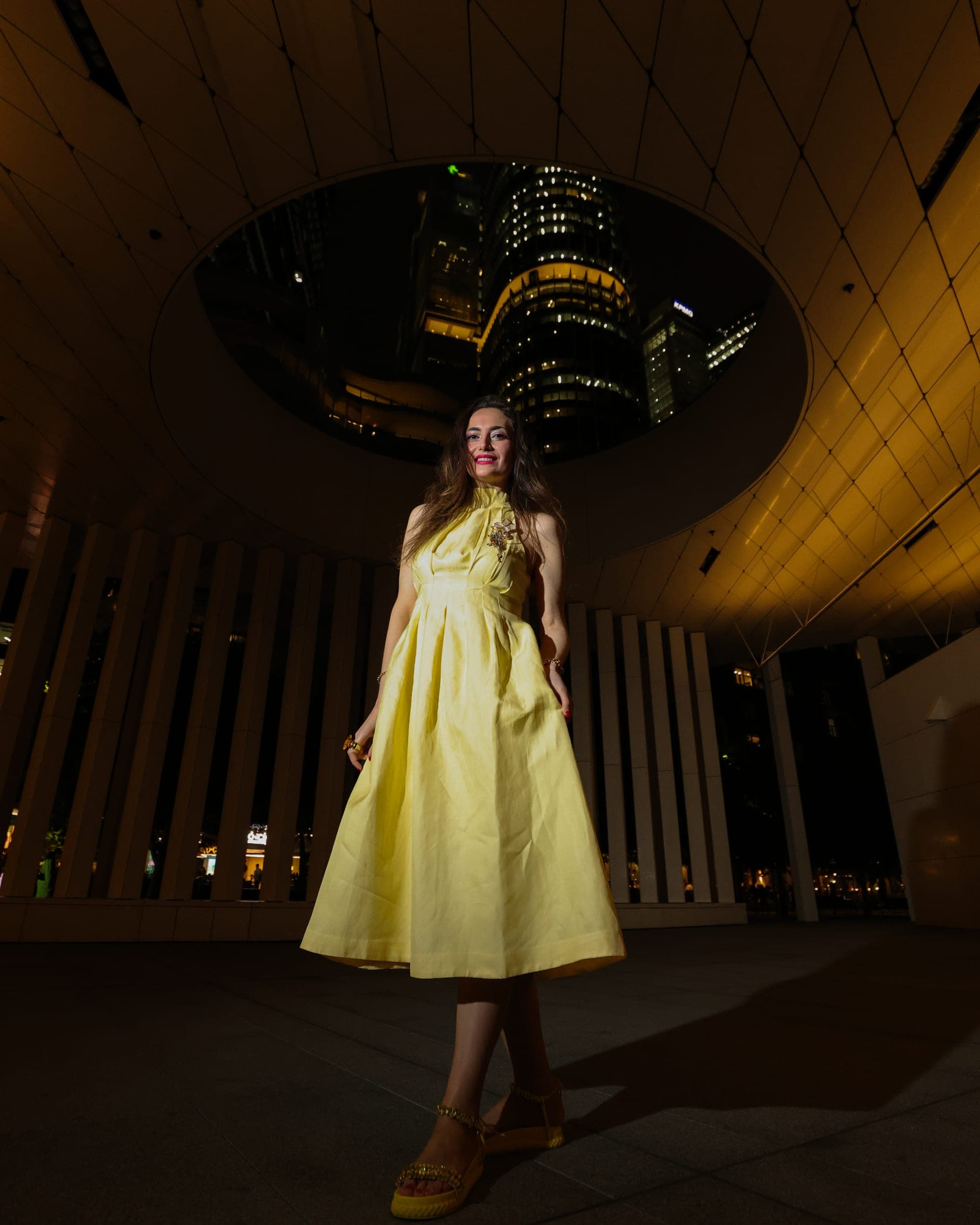 Model in a yellow satin dress at a Sydney harbourside building at night, editorial fashion photography
