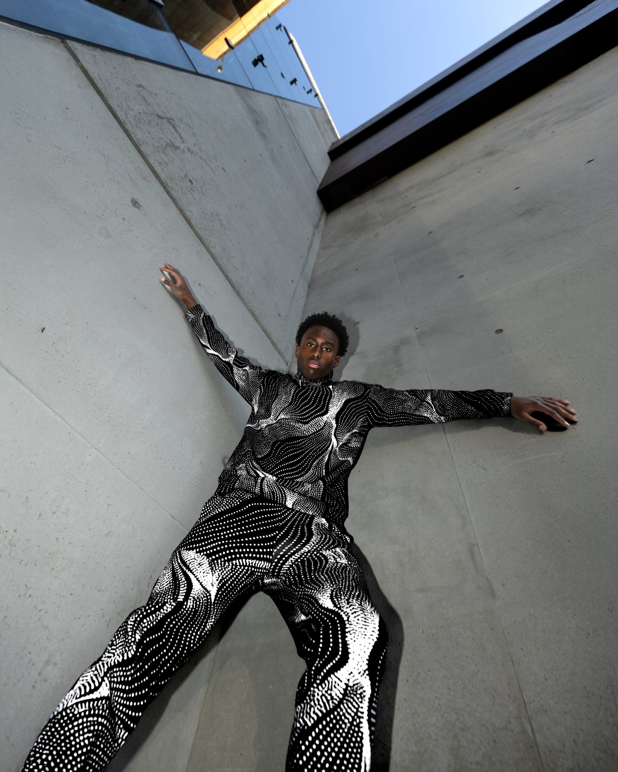 Model in a patterned suit under Sydney contemporary art museum signage, street style photography